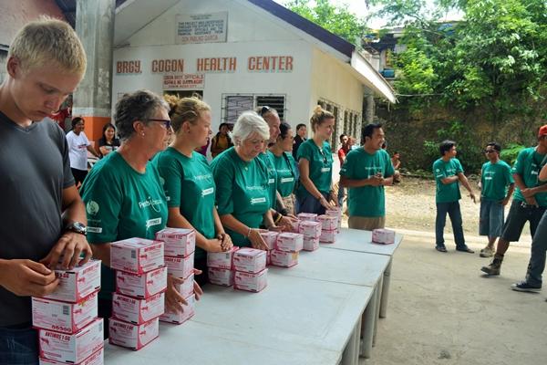 Volunteers hand out larvicide to representatives of 29 barangays of Bogo City, Philippines. Projects Abroad volunteers distribute boxes of larvicide to locals during a campaign to prevent the spread of dengue in the Philippines.