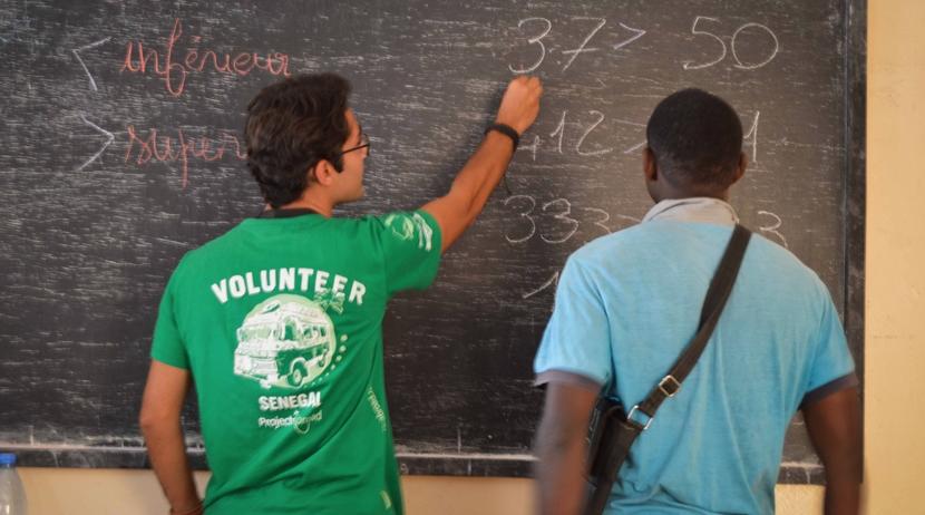 A Projects Abroad volunteer teaches a former talibe at a micro-finance centre