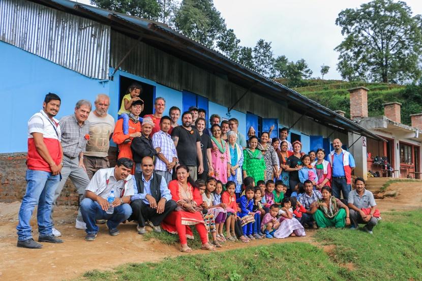 Projects Abroad staff and volunteers, along with members of the Nepal Youth Foundation, welcome students and teachers to their new classroom Projects Abroad staff and volunteers, along with members of the Nepal Youth Foundation, welcome students and teachers to their new classroom
