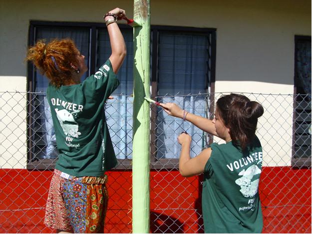 Projects Abroad Volunteers Painting Together Volunteers painting together on a project with Projects Abroad