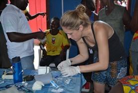 Medicine & Healthcare Ghana 19+ Public Health volunteer assists staff at an outreach.