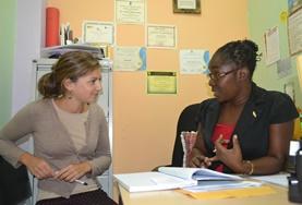 Care A volunteer discusses a patient with a psychologist in Jamaica.