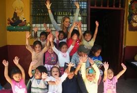 Care A volunteer with children at a day care center in Peru.