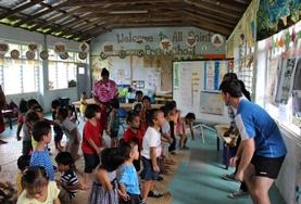 Samoa Volunteers on the Community Village Project in Samoa learn a dance from local children.