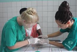 Electives for Medical<br /> Students Students on the Pharmacy School Elective in Ghana work with a local girl.