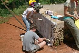 Building High School Special volunteers in Jamaica on the General Building Project paint a wall at their placement.