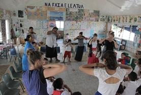 Samoa Care & Community High School Special student volunteers teach students an English song.