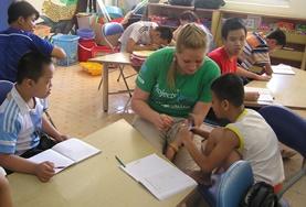 Vietnam Care & Community High School Special volunteers in Vietnam talk to children during an activity in class.