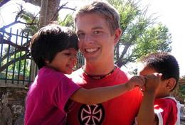 Argentina A volunteer plays with children on the playground as part of his Care & Spanish High School Special in Argentina.