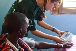 Tanzania A volunteer on the Public Health High School Special in Tanzania checks a patient's vital signs.
