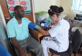 Belize A High School Special Public Health student volunteer takes a man's blood pressure reading in Belize.