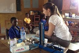 Medicine & Healthcare A Medicine High School Special volunteer checks a young boy's vital signs in Ghana.