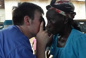 Medicine Volunteer Does Medical Checkup on Elderly Woman Volunteer on the Medicine & Healthcare Elective performs an eye check on an elderly woman abroad