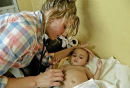 Medical Volunteer Works in Pediatrics with Projects Abroad Volunteer on the Medicine & Healthcare project check the heartbeat of a baby in the pediatrics ward