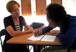 Teaching Volunteers Gives Personal Lesson to Student Volunteer on the Teaching project tutors one-on-one with a student