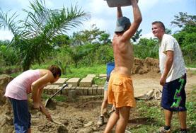 Building Volunteers Prepare Materials with Projects Abroad Volunteer on the Building project lifts heavy material for construction