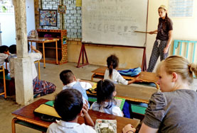 Teaching Project Volunteer Instructs Students Abroad Volunteer teaching a lesson in a school with Projects Abroad