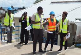International Development A volunteer on the Disaster Management Project in Jamaica addresses young children on safety measures.