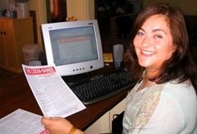 Journalism A volunteer on her Journalism Project in Bolivia shows her completed article.