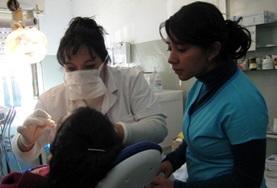 Argentina A volunteer observes her supervisor as she performs a dental procedure on a patient in Argentina.