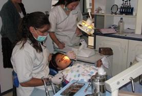 Medicine & Healthcare A dentist and volunteer on the Dentistry Internship in Bolivia prepares a young girl for her dental appointment in Bolivia.