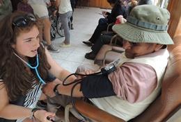 Medicine & Healthcare A volunteer and supervisor check a patient in Bolivia on the Medical Internship Abroad.