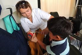 Medicine & Healthcare A Nursing volunteer in Bolivia assists a young boy at her placement.