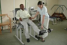 Medicine & Healthcare A man is assisted with his stretches by a student on the Ghana Physical Therapy.
