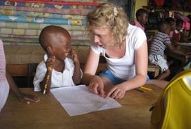 Care A social worker assists a young child in Ghana with his activity as part of an assessment.