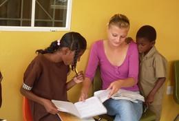 Care Jamaican children receive assistance from a professional social worker volunteering in Jamaica.
