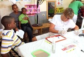 Medicine & Healthcare A professional dentist assists young children in Jamaica on the Professional Denal Project.