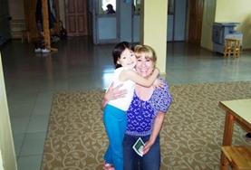 Samoa A dietitian hugs a young child after assisting her at her placement in Samoa.