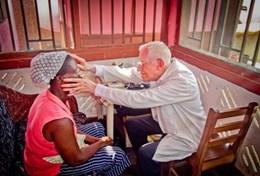 Medicine & Healthcare A volunteer doctor examines a local woman in Ghana as part of his project abroad.