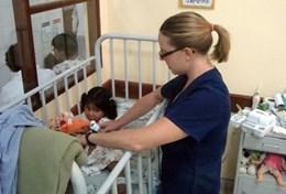 Medicine & Healthcare A professional volunteer occupational therapist works works with a young girl in Bolivia.