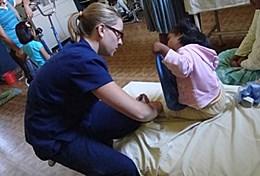 Medicine & Healthcare A physical therapist works with a child at a Bolivian hospital.