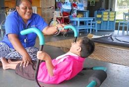 Samoa A woman uses techniques taught by a physical therapist volunteering in Samoa.