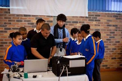 Teacher Introduces Advanced Technology to Students in South Africa Professional teaching volunteer with students in IT class in South Africa