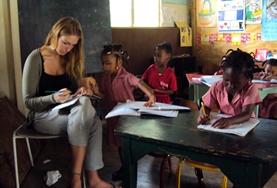 Teaching A professional teacher volunteering in Jamaica leads an adult literacy class for the local community.