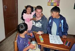 Teaching A special needs teacher volunteering in Bolivia helps children with an educational activity.