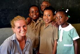 Teaching A volunteer teaches English to a small group of children at a school in Jamaica.