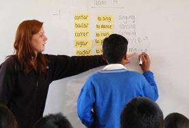 Teaching A volunteer teaches English at a high school in Peru.
